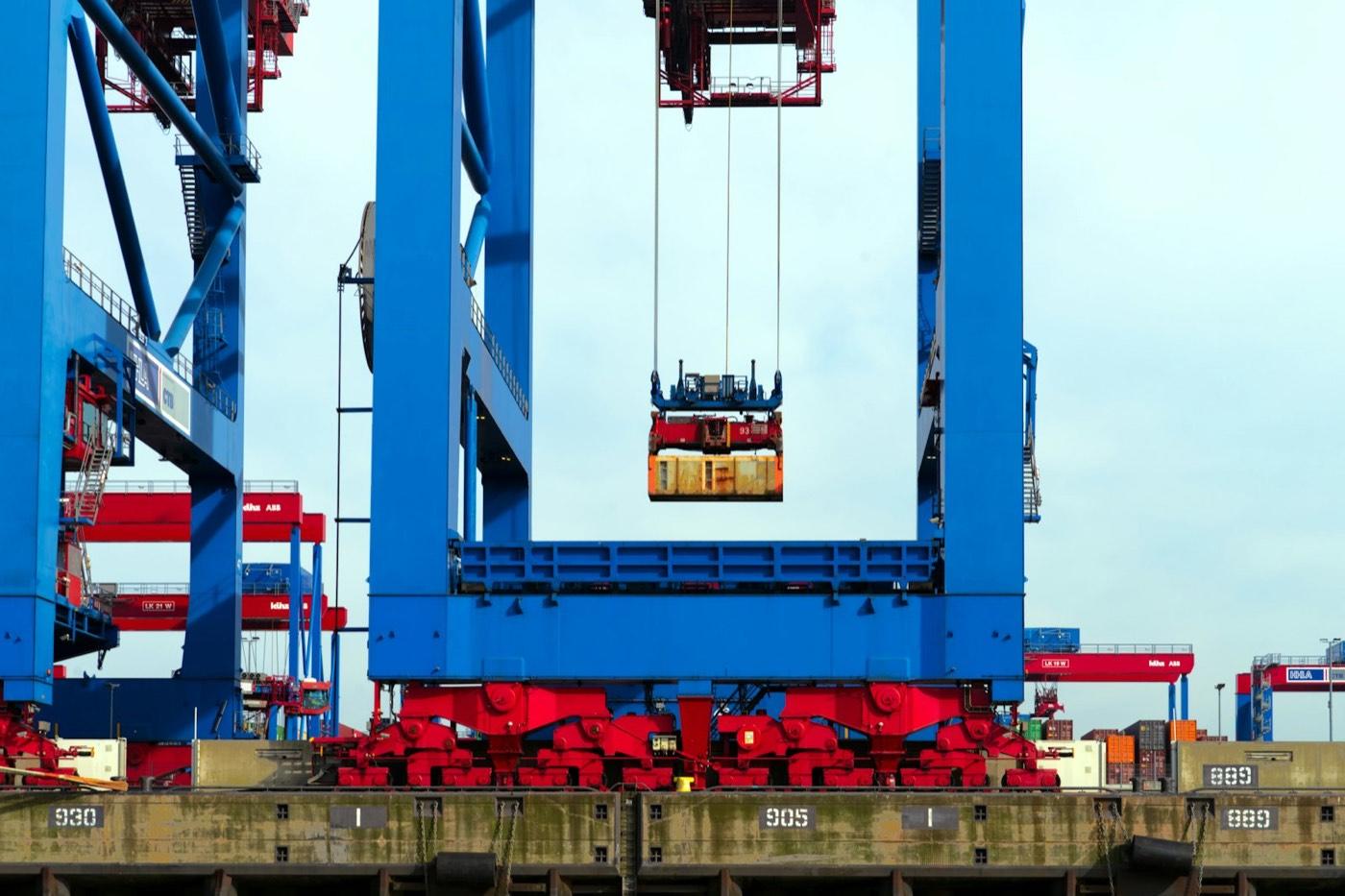 A ship-to-shore gantry crane lifting a container at a marine terminal